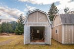 Locking storage shed for guest use to store skis, bikes, toys. Inside you`ll find roasting sticks for use with the large fire pit, as well as patio chairs and lawn games like bocce ball.